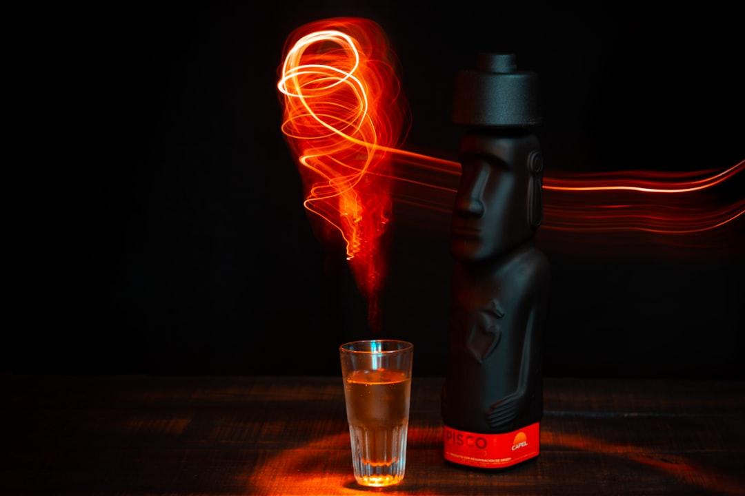 Bodegon of alcoholic drink with dark predominance decorated with light painting.